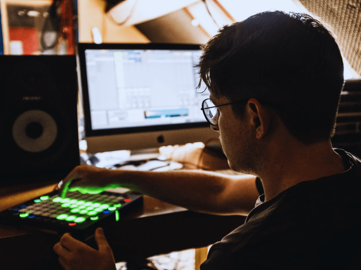 Young organiser with laptop at event venue